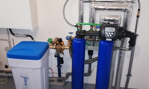 Duplex water softening system in a single-family house